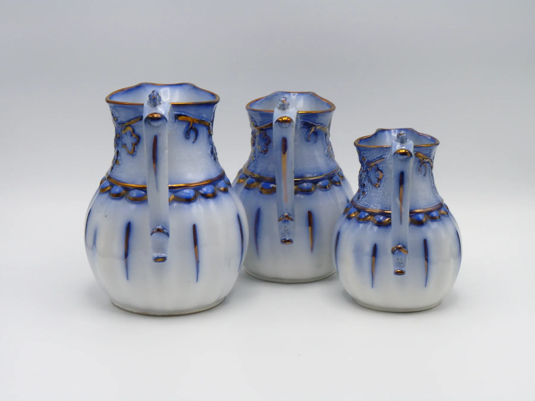 3 Graduating Flow Blue & Copper Lustre Relief Moulded Jugs - Image 2