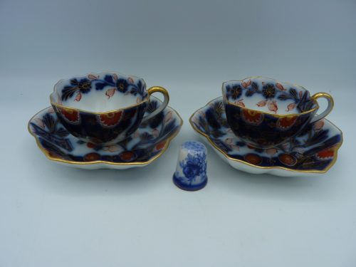 Pair of Flow Blue Polychrome Highlighted with gold Miniature Cups and Saucers