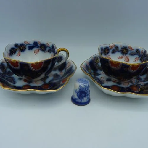 Pair of Flow Blue Polychrome Highlighted with gold Miniature Cups and Saucers
